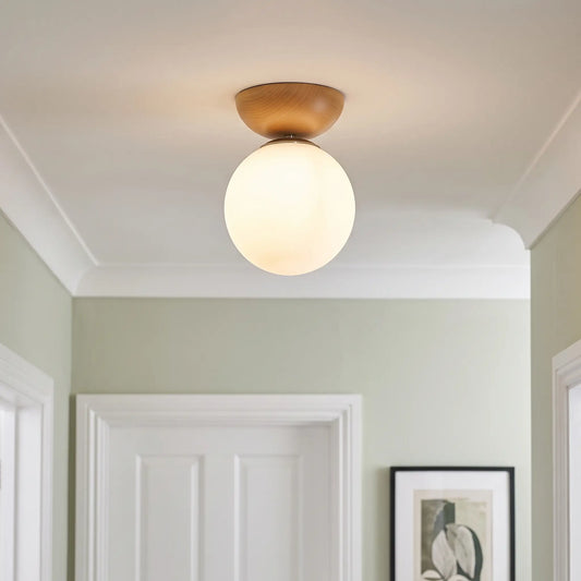 Wood and opal glass globe semi flush ceiling light – Teak – in a hallway