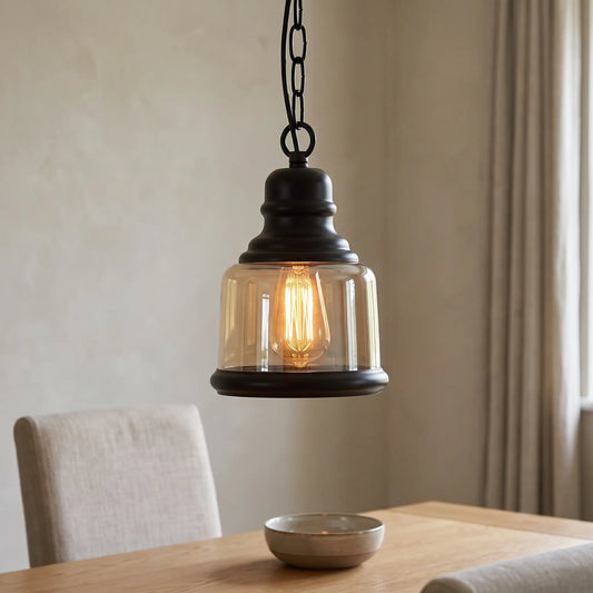 Amber glass industrial pendant light – Bell shade – over a dining table