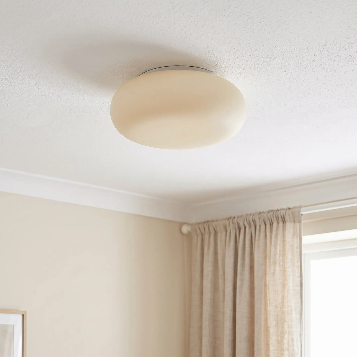 Cloud pebble flush ceiling light – switched off in a bedroom