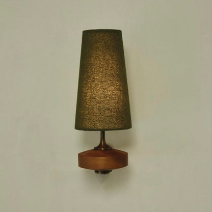 Green fabric wall light on a sage wall