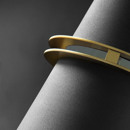 Close-up of brass ring on black cone shade