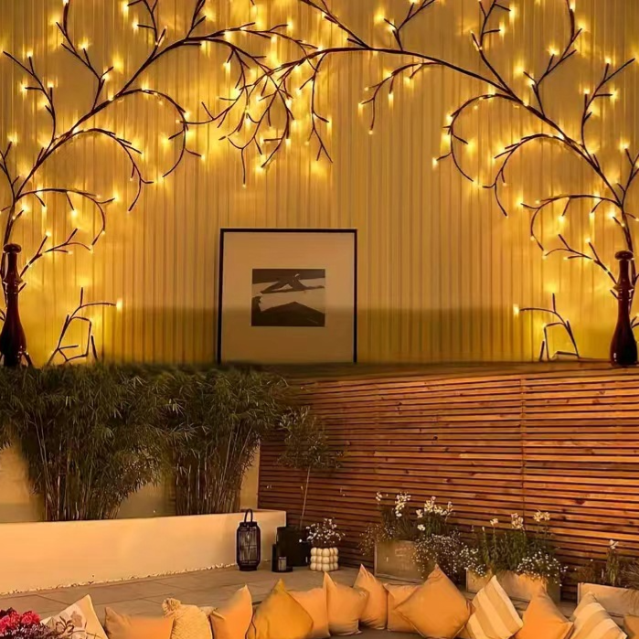 LED rattan twig lights arched over a sofa wall, lit warm white