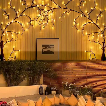 LED rattan twig lights arched over a sofa wall, lit warm white