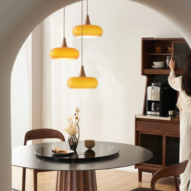 Amber Nordic glass pendant lights over a round dining table
