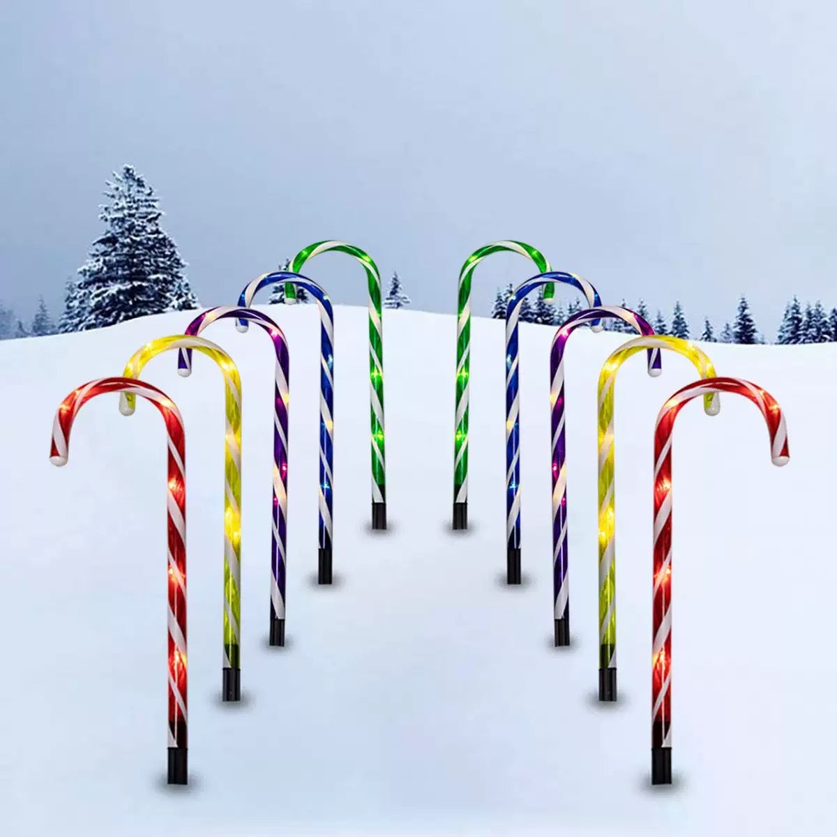 Candy cane path lights – multicolour, lit along a snowy path
