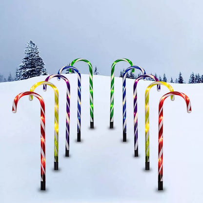Candy cane path lights – multicolour, lit along a snowy path