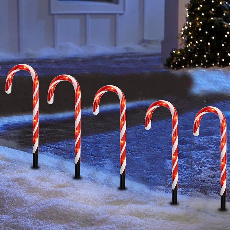 Candy cane path lights – red & white, lit along a snowy path