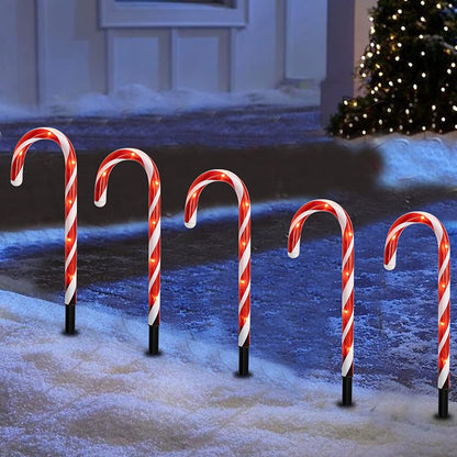 Candy cane path lights – red & white, lit along a snowy path