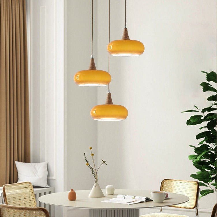Three amber Nordic glass pendant lights in a living room