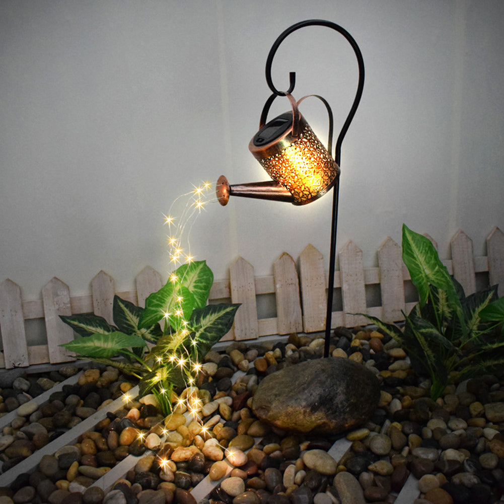 Solar powered watering can light creating cascading light effect