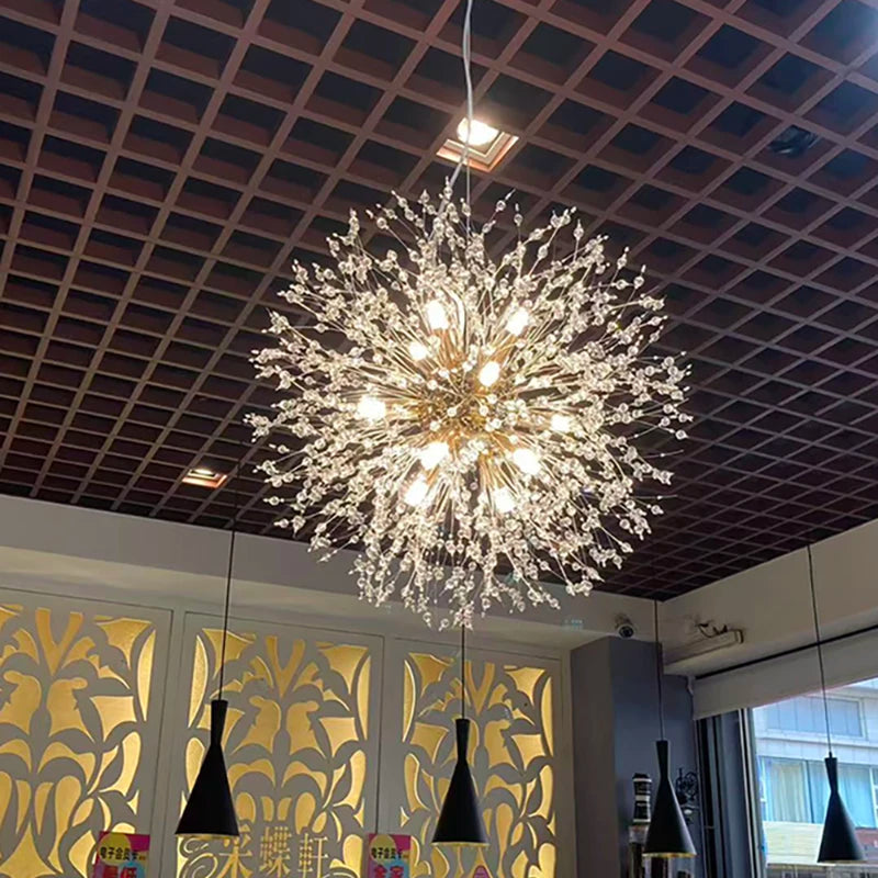 Gold dandelion sphere chandelier lit against a dark wall