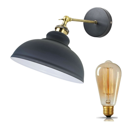 Vintage industrial dome wall light lit above a desk