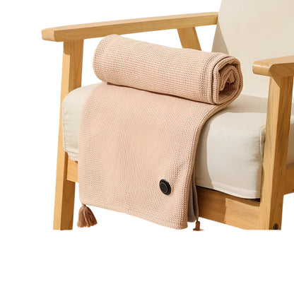 Heated throw blanket rolled and resting on a wooden armchair