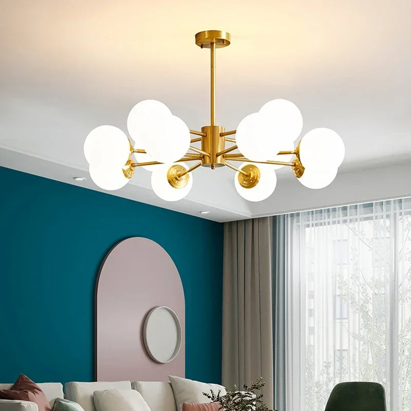 Gold glass globe chandelier above a teal painted living room