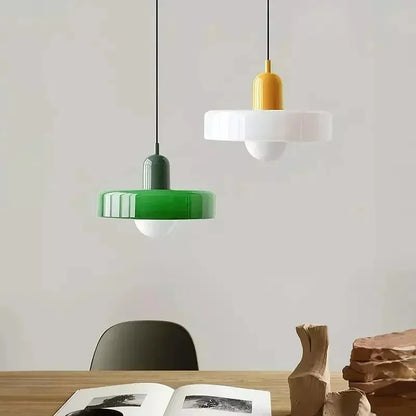 Retro two-tone fluted glass pendant lights above a dining table