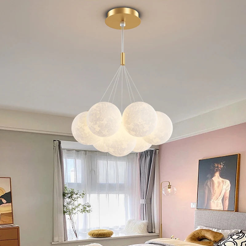 Cluster of glowing moon globes on a gold ceiling canopy