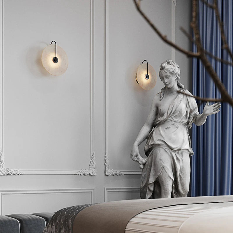 Two small marble wall lights on a classical panelled wall