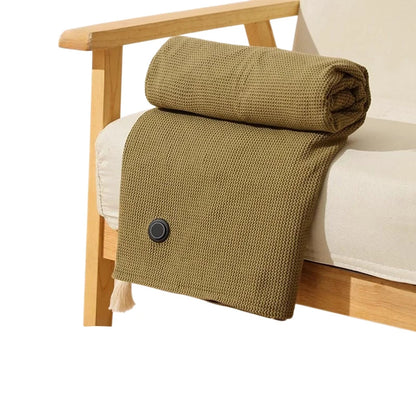 Olive green heated throw rolled on a light wood armchair
