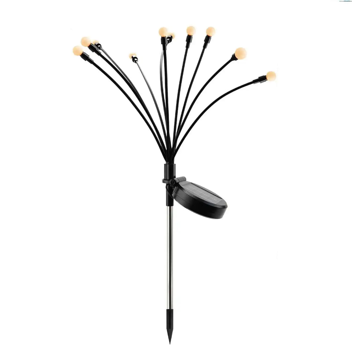 Solar firefly garden lights swaying above lawn and planting at night