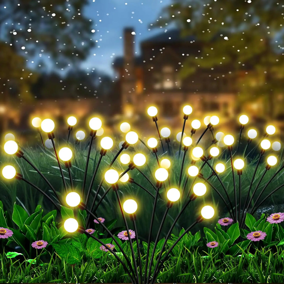 Warm white solar firefly stake lights lighting a garden pathway at dusk