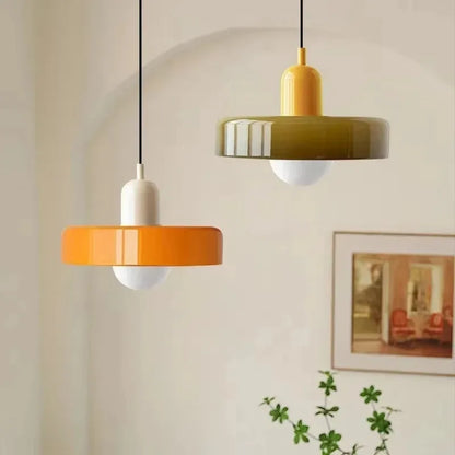 Mustard and olive fluted glass pendant lights above a kitchen counter