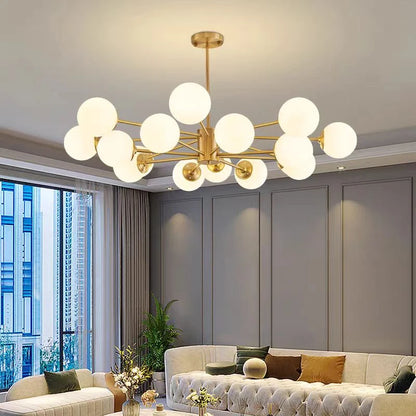 Gold glass globe chandelier lit above a living room seating area