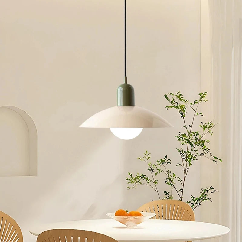 Retro macaron saucer pendant light above a round dining table
