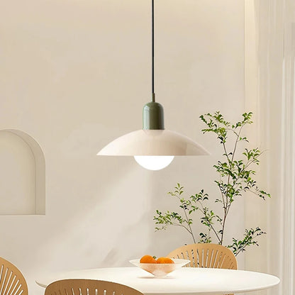 Retro macaron saucer pendant light above a round dining table