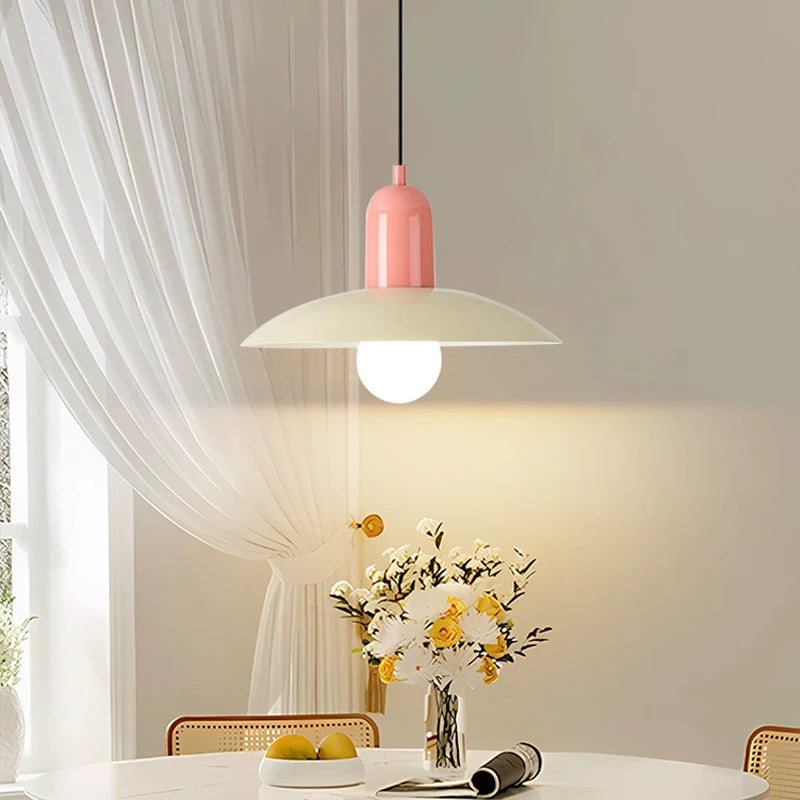 Retro saucer pendant light lit above a bistro table