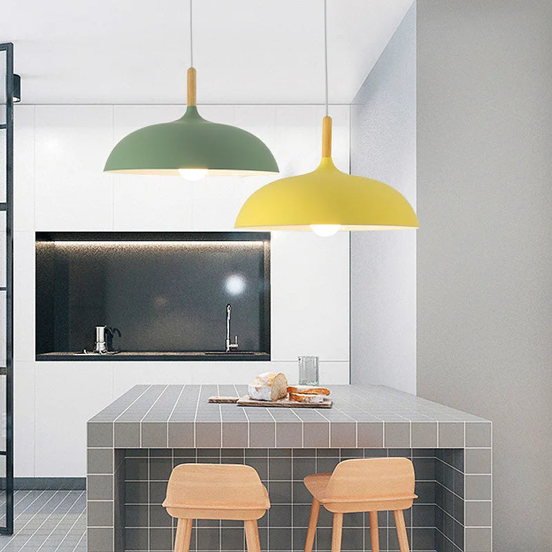 Nordic pendant light with oak stem lit above a breakfast bar
