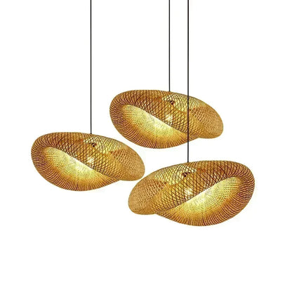 Three hand woven bamboo pebble lamp shades on a plain background