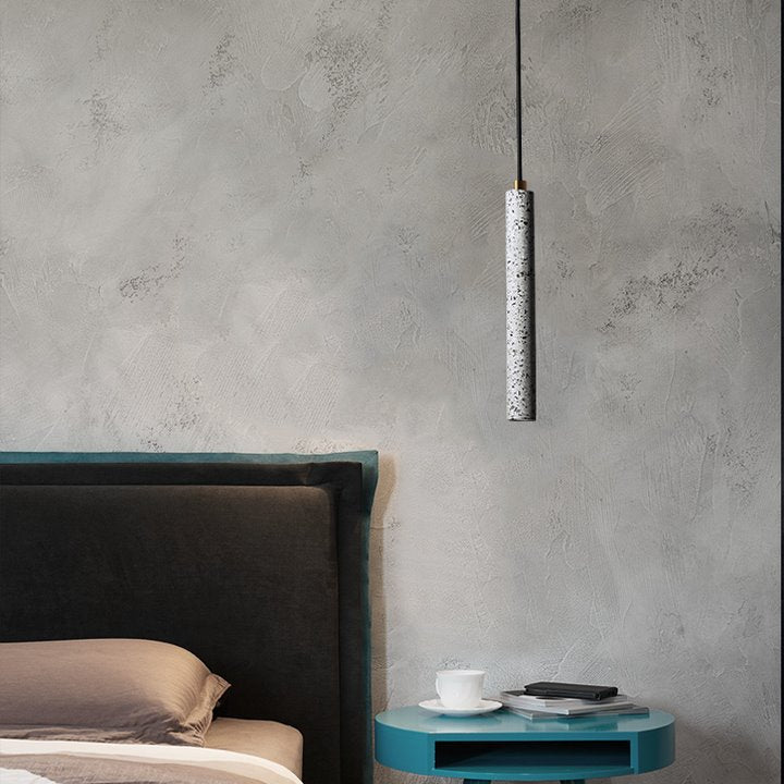 White terrazzo tube pendant above a bedside