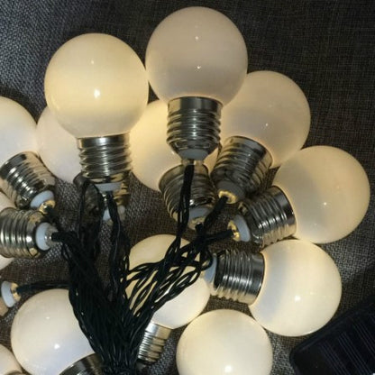 Warm white solar fairy lights wrapped around garden trellis
