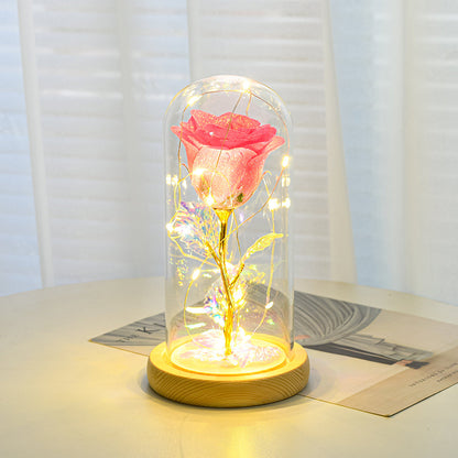 LED preserved rose lamp illuminated in dark bedroom
