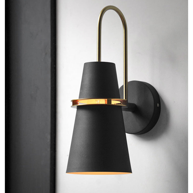 Black cone wall light with brass ring and curved arm