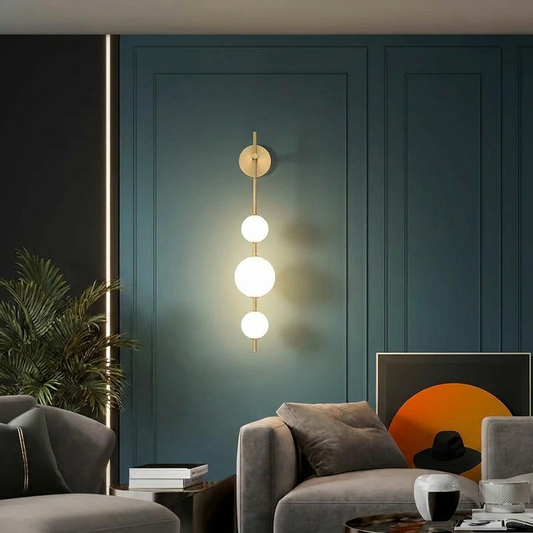 Vertical LED wall light aluminium sconce with three glass globes in modern living room