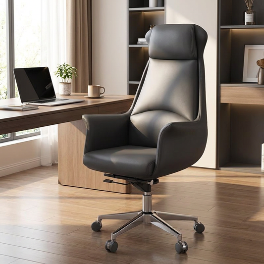 Executive PU leather office chair in dark grey styled at a modern home office desk with warm natural lighting
