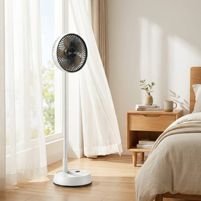 White oscillating tower fan standing beside bedside table in bright airy bedroom