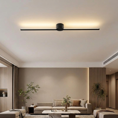 Erix Linear Flush Mount Ceiling Light in black, up glow, in a modern minimalist living room