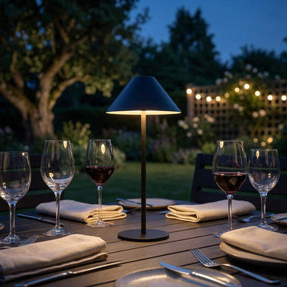 Black portable LED table lamp on an outdoor dining table