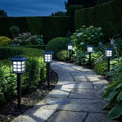Solar pathway lights with white glow lining a stone path