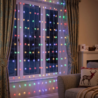 Multicolour LED snowflake curtain lights, 3m indoor fairy string lights hung in a UK bedroom
