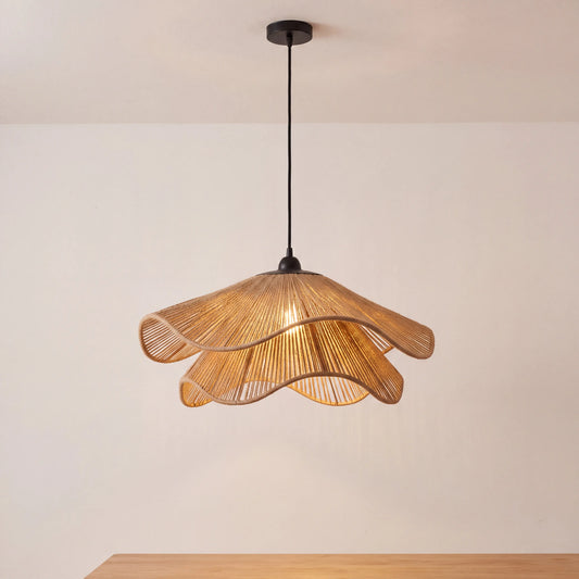 Woven jute rope scalloped pendant light shade hanging over a dining table in a UK kitchen