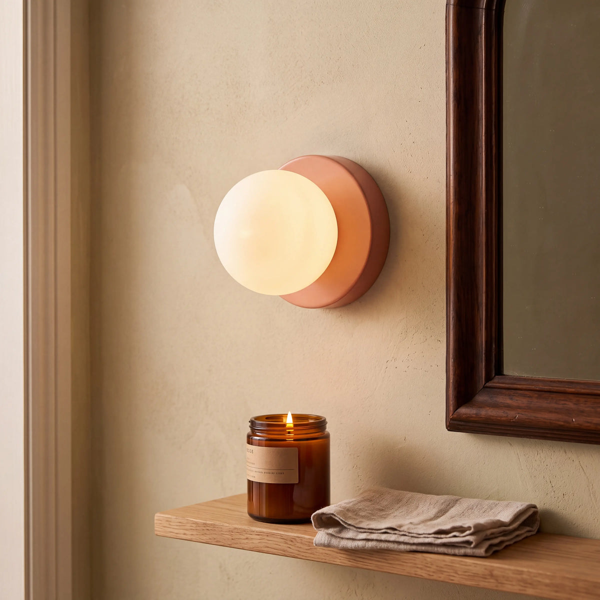 Terracotta mini macaron glass globe wall sconce, wall mounted in a UK porch