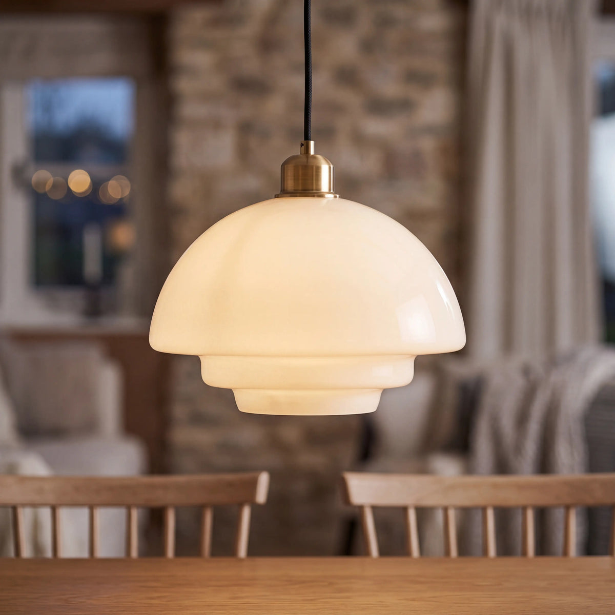 White bell glass pendant light, 28 by 19cm, E27 hanging lamp over a UK bar counter