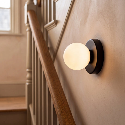 Black mini macaron glass globe wall sconce, wall mounted in a UK hallway