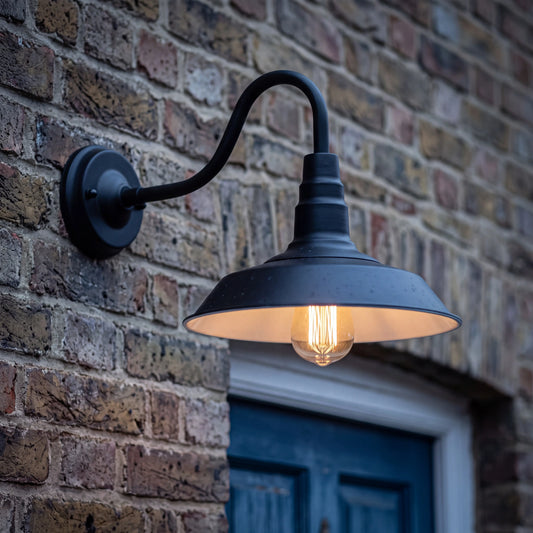 Black ridged shade retro outdoor barn wall light, 40cm arm, E27 vintage garden lamp on a UK courtyard wall