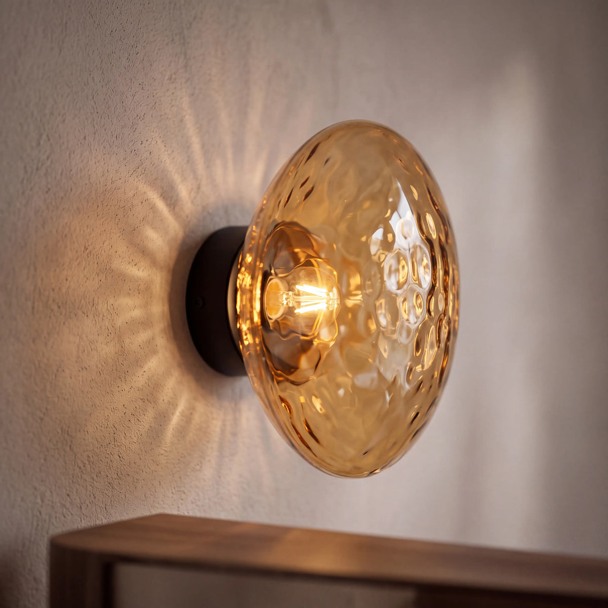 Black and amber dimpled glass wall sconce, flush style D15cm, wall mounted in a UK bedroom