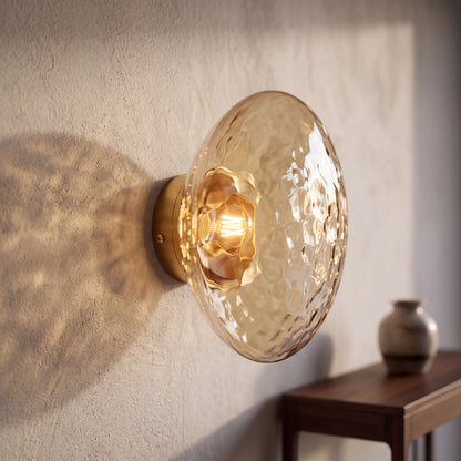 Gold and amber dimpled glass wall sconce, flush style D15cm, wall mounted beside a UK bed