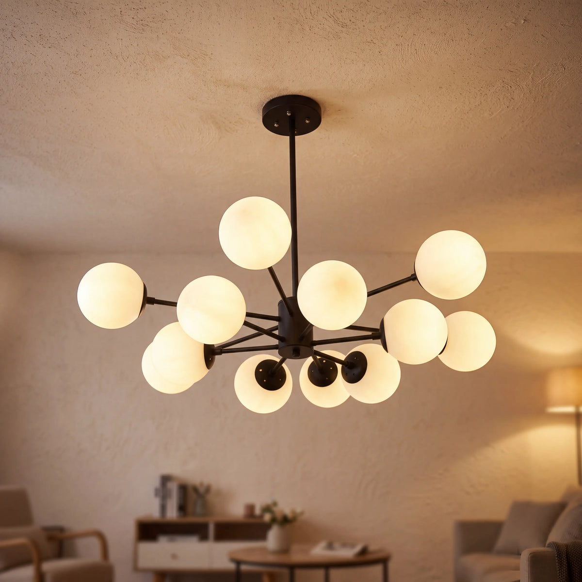 Modern glass globe chandelier with 12 lights and a black frame, lit in a living room